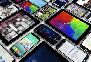 render of a collection of smartphones and tablets with different screens